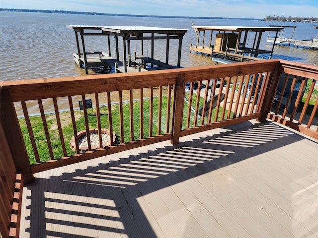 wooden terrace featuring a yard, a dock, and a water view