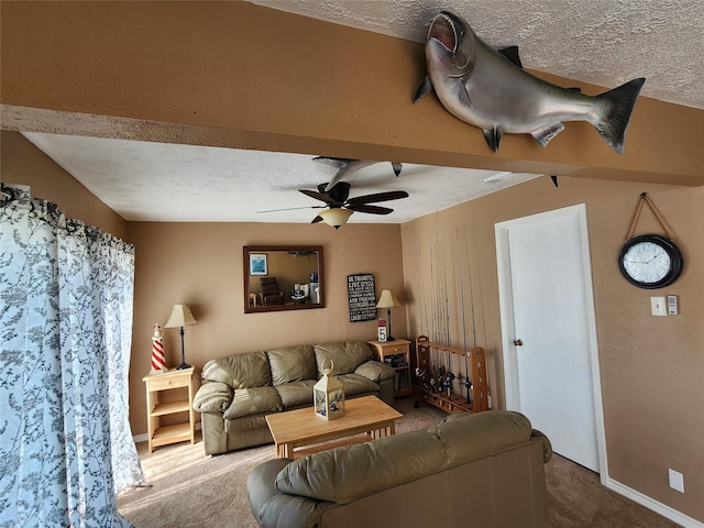 living area featuring a ceiling fan, carpet flooring, and a textured ceiling