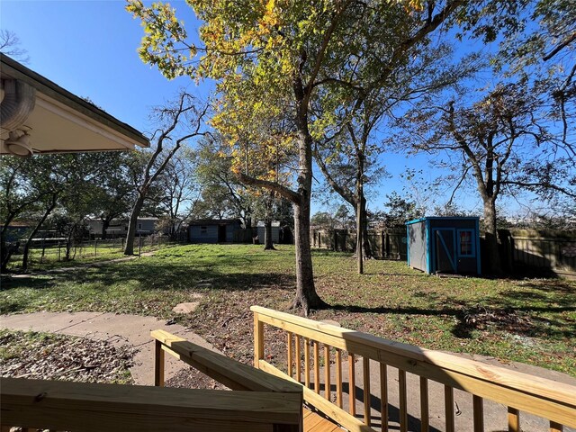 view of yard with a storage unit and a deck