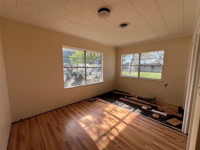 unfurnished room featuring hardwood / wood-style flooring