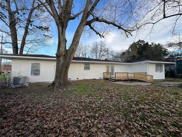 back of property with central air condition unit and a deck