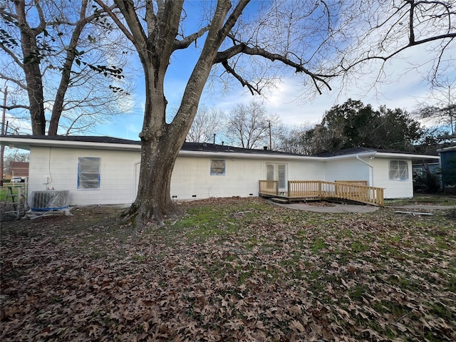 back of house with a wooden deck and central AC unit