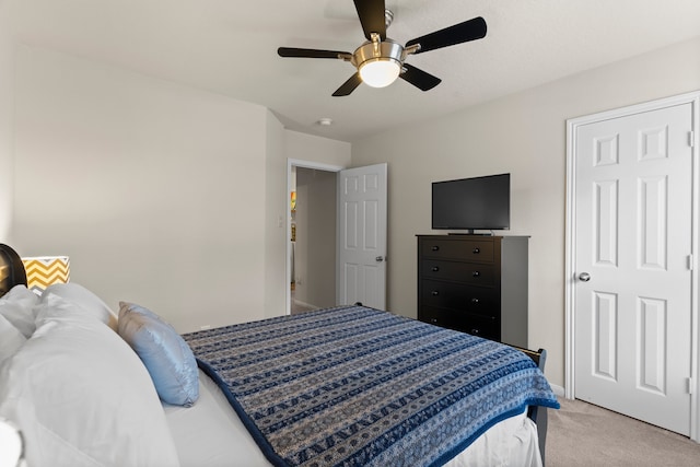 bedroom with ceiling fan and light carpet