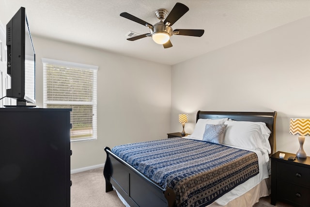 bedroom with ceiling fan and light colored carpet