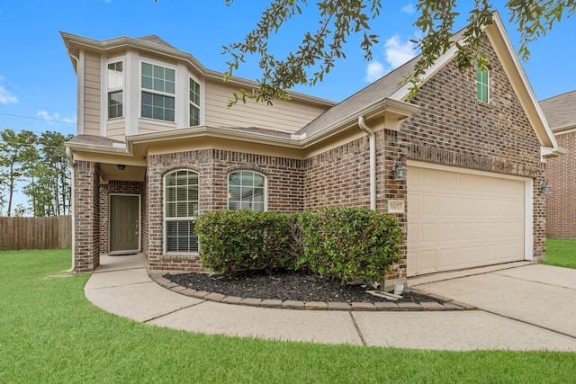 view of property with a garage and a front yard