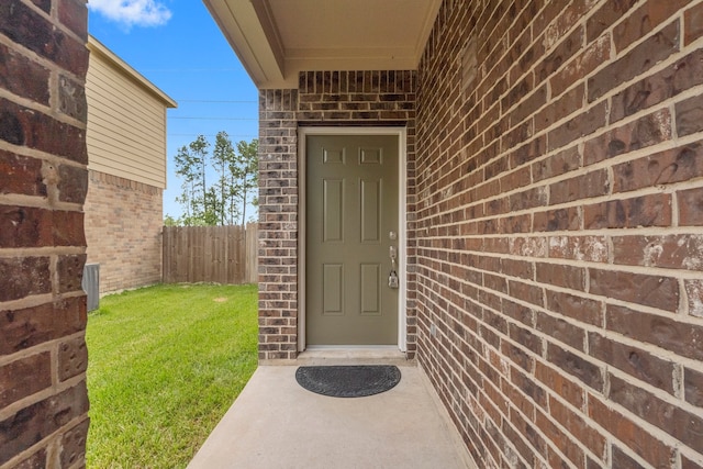 doorway to property with a yard