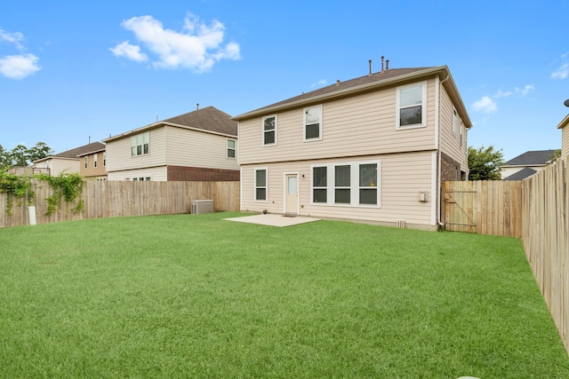 rear view of house featuring a yard, cooling unit, and a patio