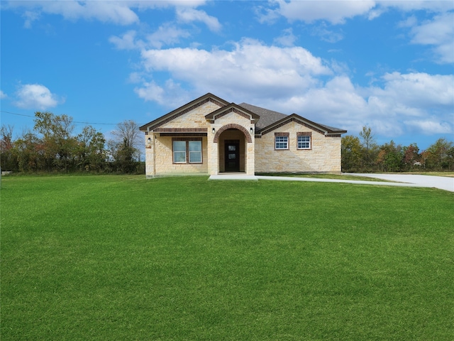 view of front facade featuring stone siding and a front yard