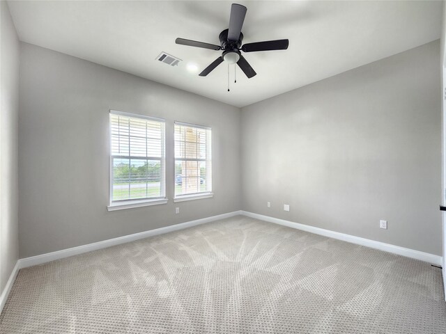 spare room featuring carpet flooring and ceiling fan