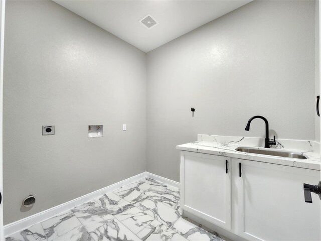 clothes washing area featuring washer hookup, hookup for an electric dryer, cabinets, and sink