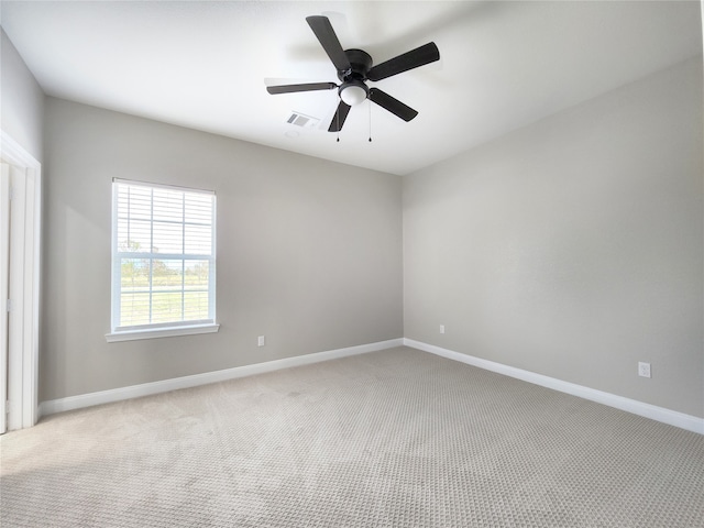 empty room with ceiling fan and light colored carpet