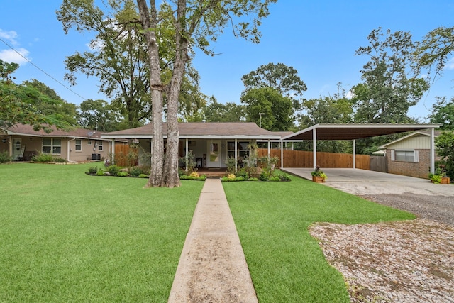 single story home with a porch, a front lawn, and a carport