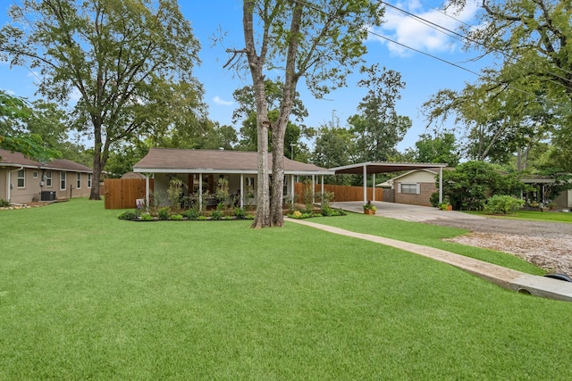 view of front facade featuring central air condition unit, a carport, and a front lawn