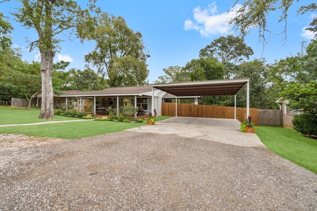 single story home with a front yard and a carport