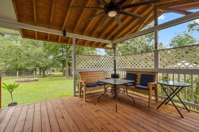 wooden terrace featuring a lawn and ceiling fan