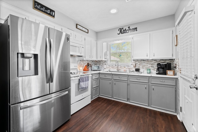 kitchen with gray cabinets, white appliances, dark hardwood / wood-style flooring, and sink