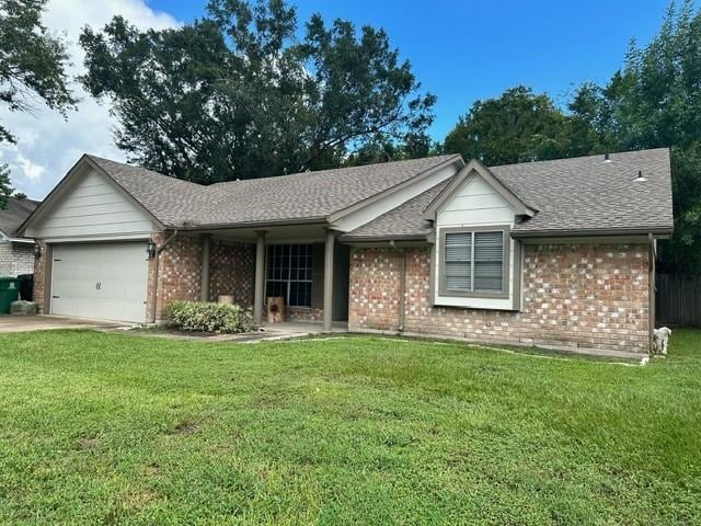 7410 Ashmole Ln, Houston, TX 77088 - ranch-style house featuring brick siding, a garage, a front lawn, and roof with shingles