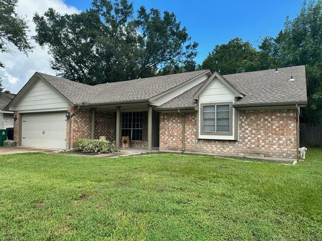 7410 Ashmole Ln, Houston, TX 77088 - ranch-style house featuring brick siding, an attached garage, a front yard, and roof with shingles