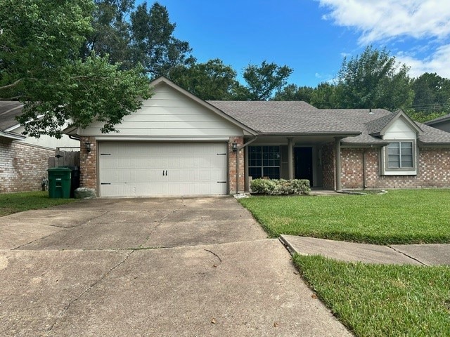 ranch-style home with a garage and a front lawn