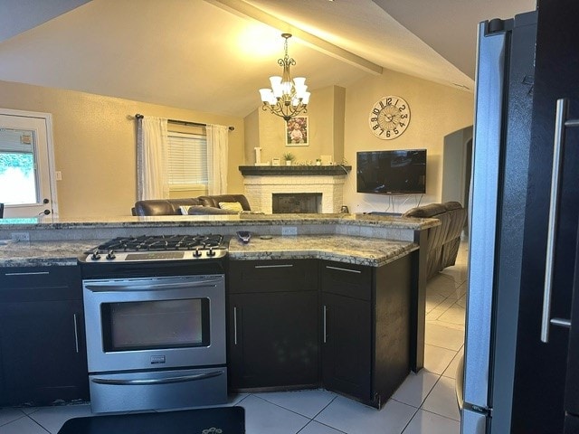 kitchen featuring pendant lighting, stainless steel gas range, a chandelier, light tile patterned floors, and vaulted ceiling with beams