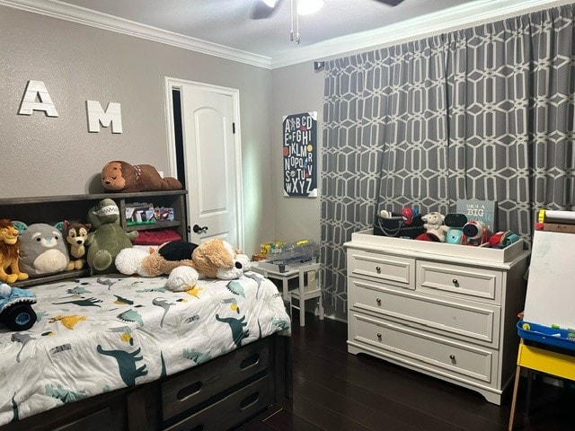 bedroom featuring crown molding, dark wood-type flooring, and ceiling fan