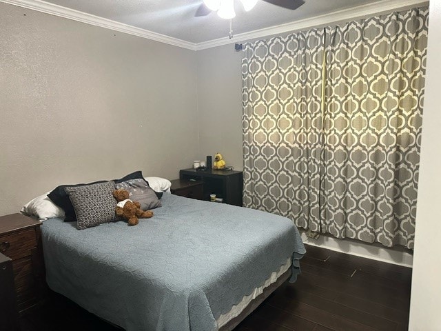 bedroom featuring ceiling fan, ornamental molding, and hardwood / wood-style floors