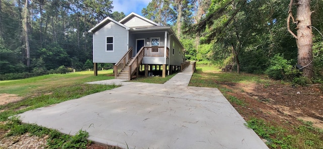 view of front of property with stairway, a porch, and a front yard