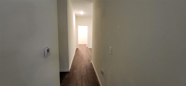 hall featuring dark wood finished floors and baseboards