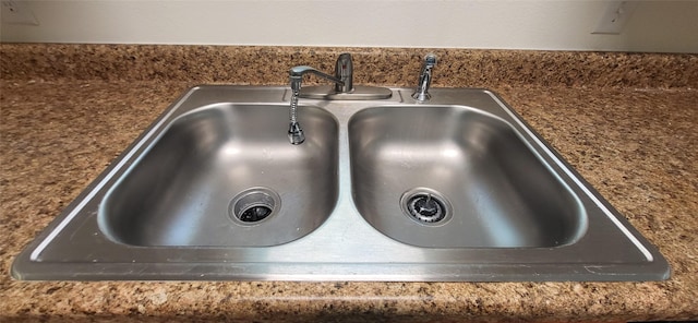 interior details with dark countertops and a sink