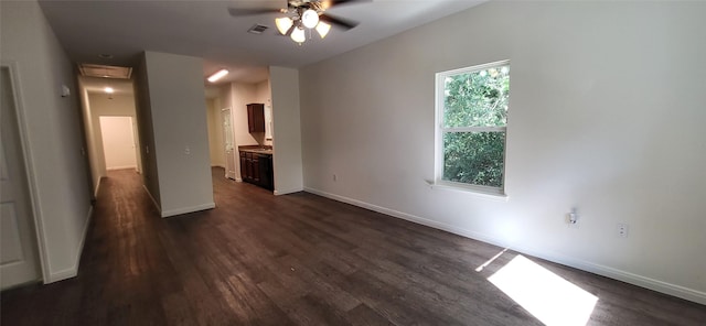 unfurnished bedroom featuring ensuite bath, baseboards, visible vents, and dark wood-style flooring