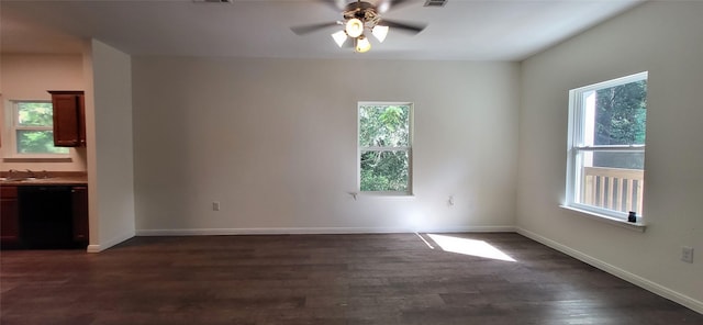 spare room with a sink, baseboards, ceiling fan, and dark wood-style flooring