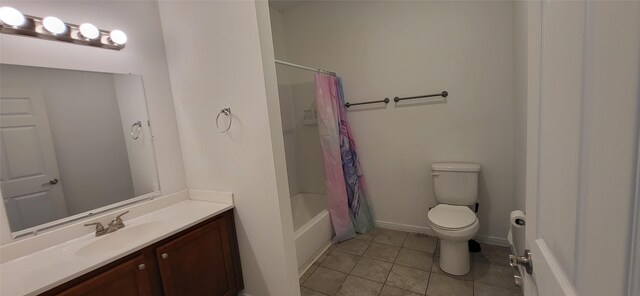 bathroom featuring baseboards, toilet, shower / tub combo, tile patterned floors, and vanity