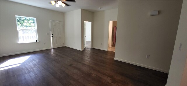 entryway featuring dark wood-type flooring, baseboards, and ceiling fan