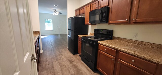 kitchen with ceiling fan, black appliances, brown cabinets, and light wood-style floors