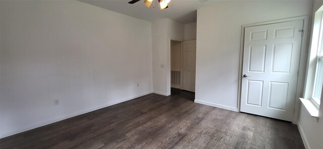 unfurnished bedroom with dark wood finished floors, visible vents, a ceiling fan, and baseboards