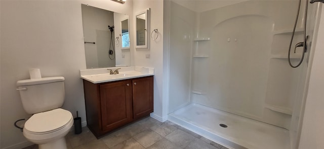 full bathroom with a stall shower, toilet, vanity, and baseboards