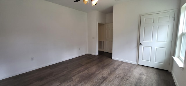 unfurnished bedroom featuring visible vents, baseboards, dark wood finished floors, and a ceiling fan