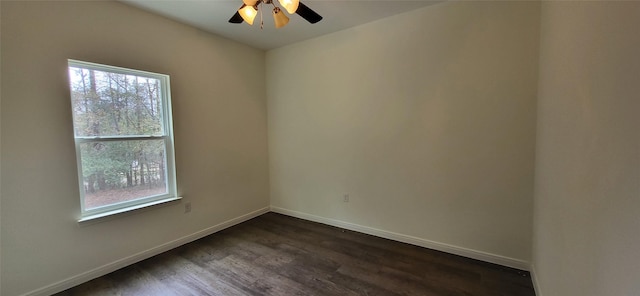 unfurnished room with a ceiling fan, baseboards, and dark wood-style flooring