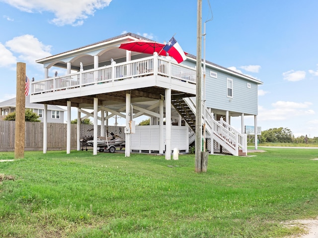 rear view of house with a lawn and a wooden deck