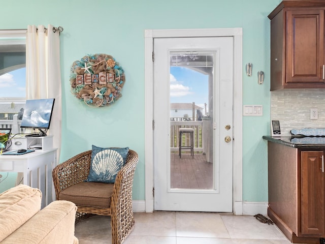 entryway featuring light tile patterned floors and a healthy amount of sunlight