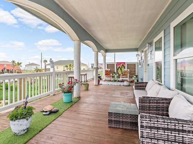 deck featuring covered porch and an outdoor living space