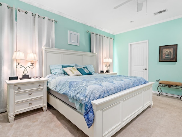 carpeted bedroom with ceiling fan and crown molding