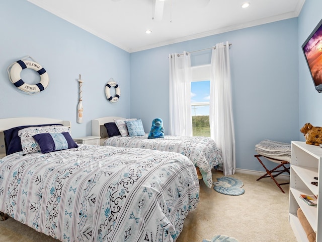 carpeted bedroom featuring ceiling fan and ornamental molding