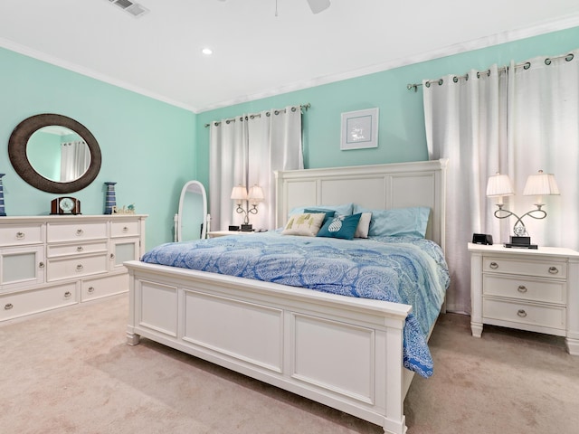 carpeted bedroom with crown molding and ceiling fan