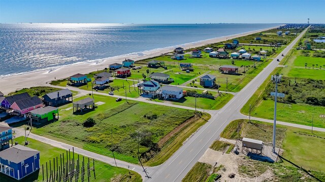 aerial view with a water view and a beach view