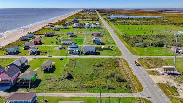 drone / aerial view with a water view and a beach view