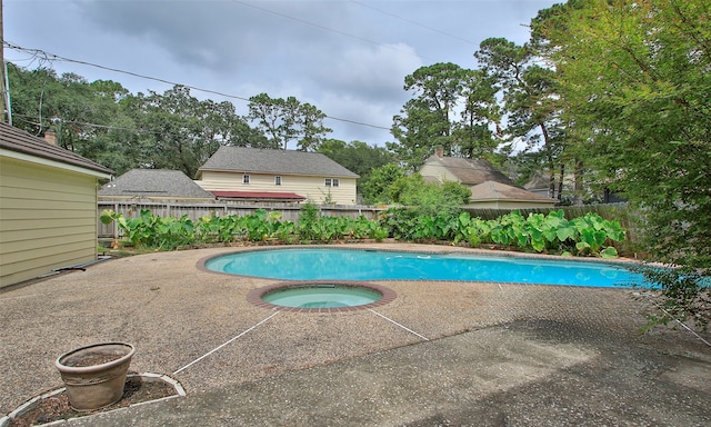 view of swimming pool with an in ground hot tub and a patio area