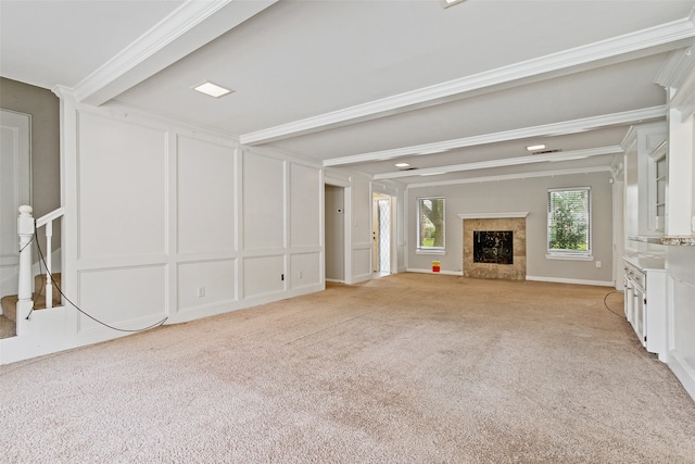 unfurnished living room with a fireplace, light carpet, and ornamental molding