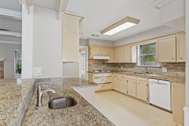 kitchen featuring white dishwasher, crown molding, light stone counters, and sink