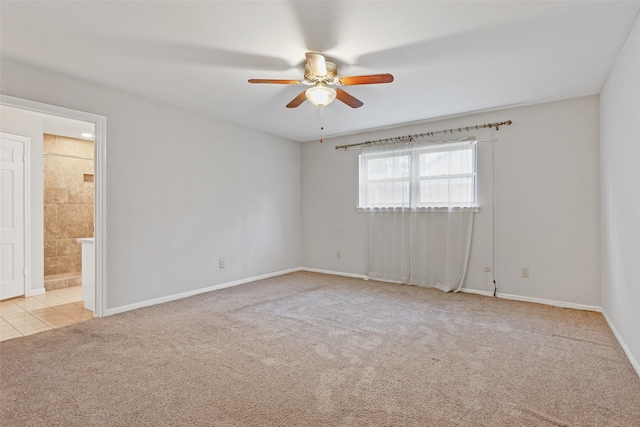 spare room featuring light carpet and ceiling fan